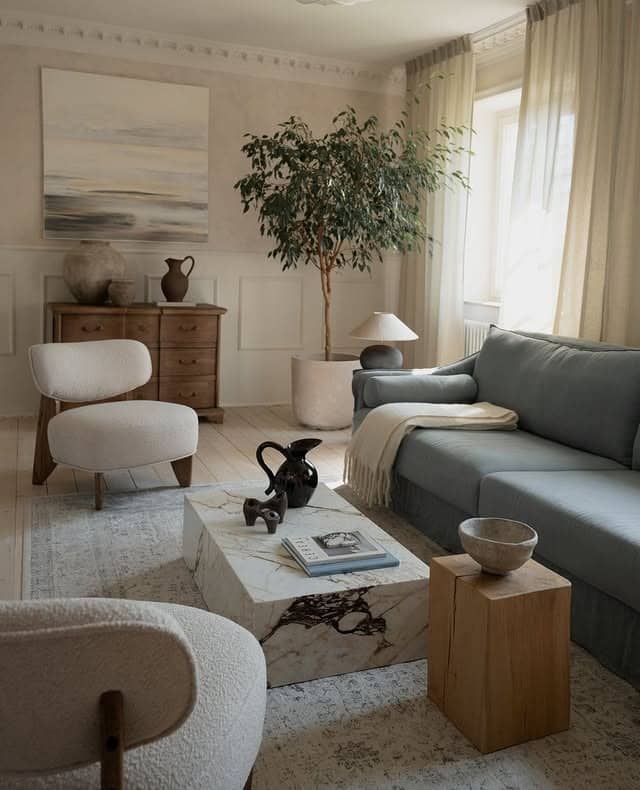 17. Dusty Blue Sofa with Scandinavian Neutral Styling - blue sofa living room ideas