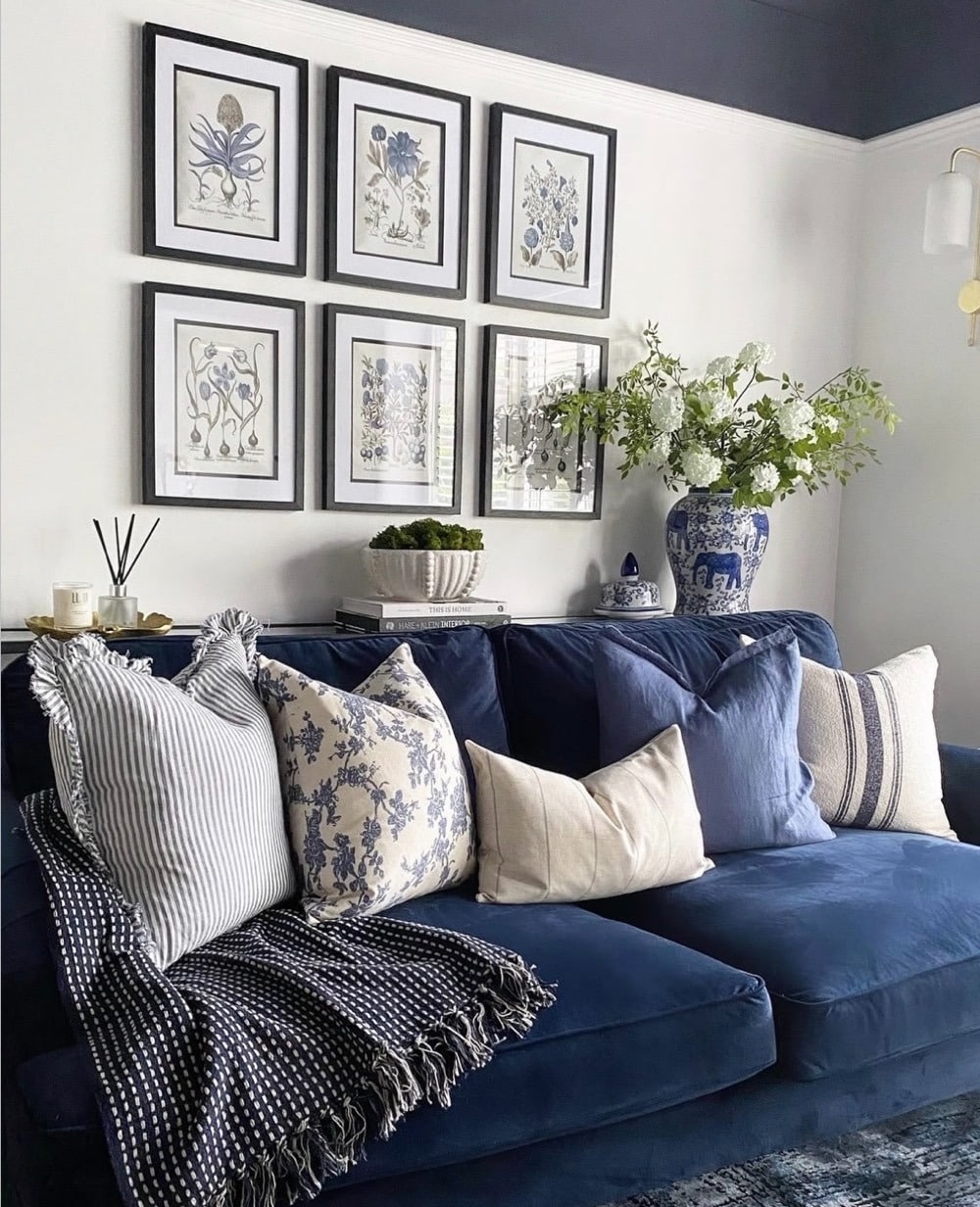 22. Classic Blue Sofa with Botanical Gallery Wall Styling - blue sofa living room ideas
