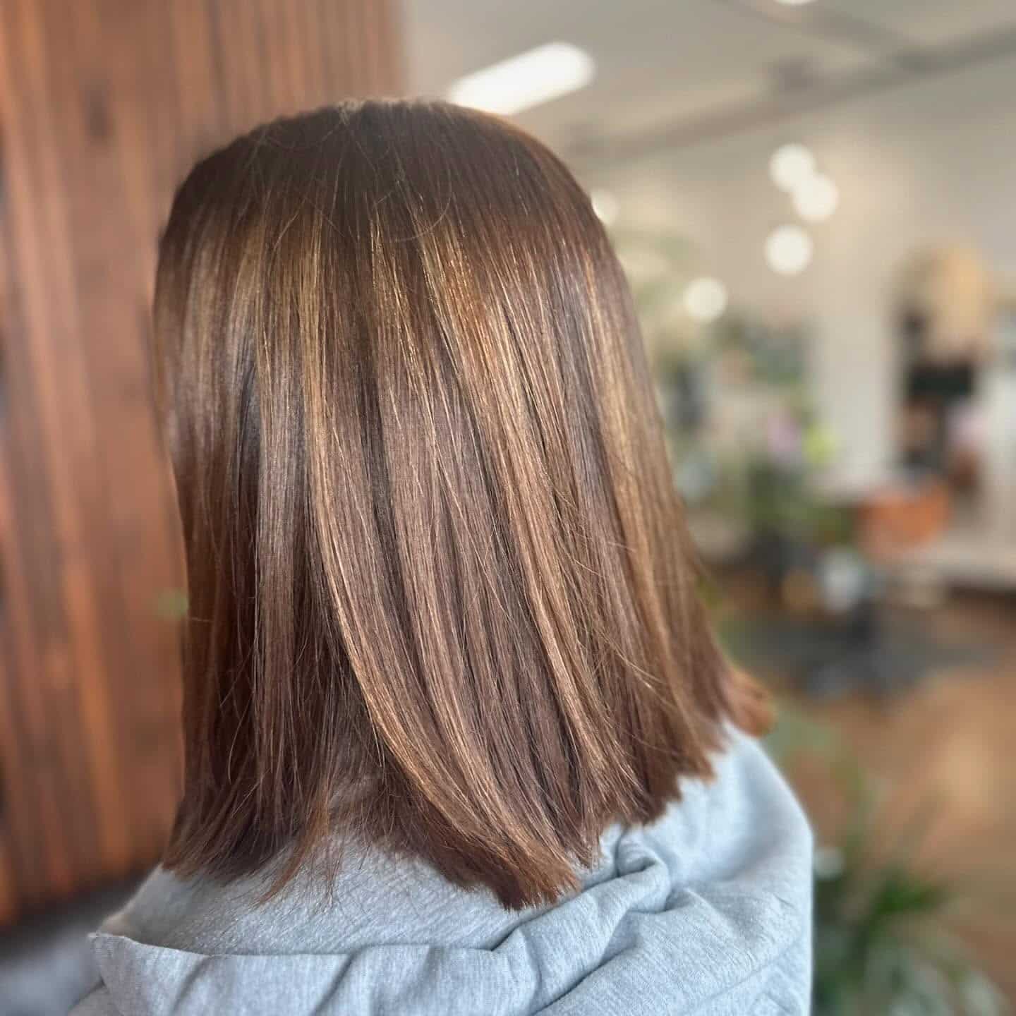 9. Sleek Straight Brunette Lob with Caramel Highlights - Long Layered Bob