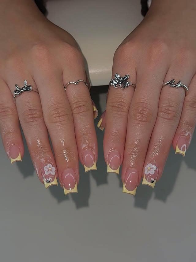 18. Pastel Yellow French Tips with Floral Detail - very short nail ideas