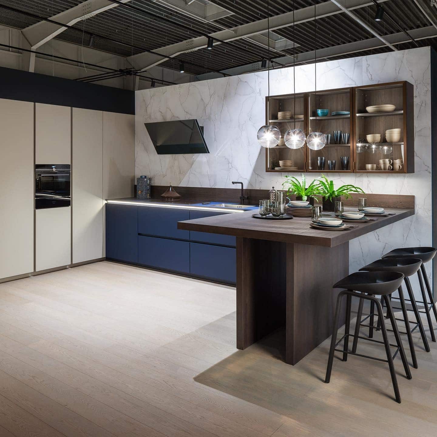 3. Contemporary Kitchen with Blue Cabinets and Marble Backdrop - big kitchen ideas