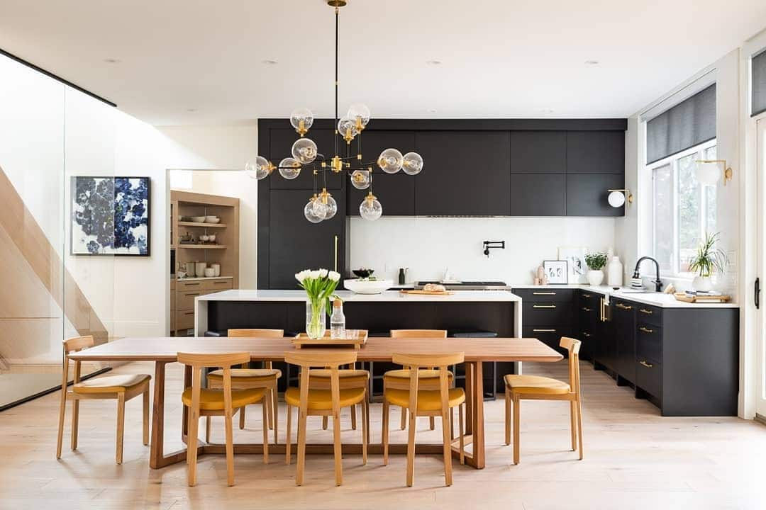 4. Black and White Kitchen with Warm Wood Dining Accents - big kitchen ideas