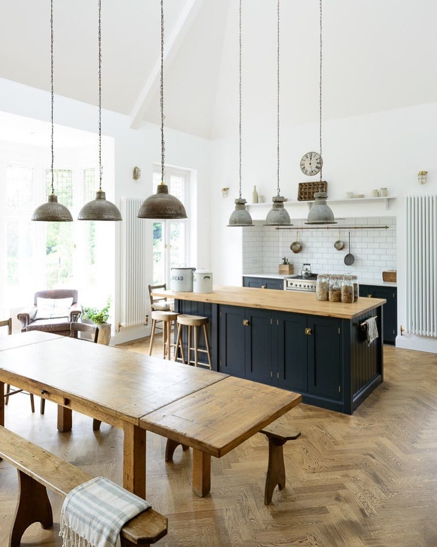 8. Classic Farmhouse Kitchen with Dark Island and Vintage Lighting - big kitchen ideas