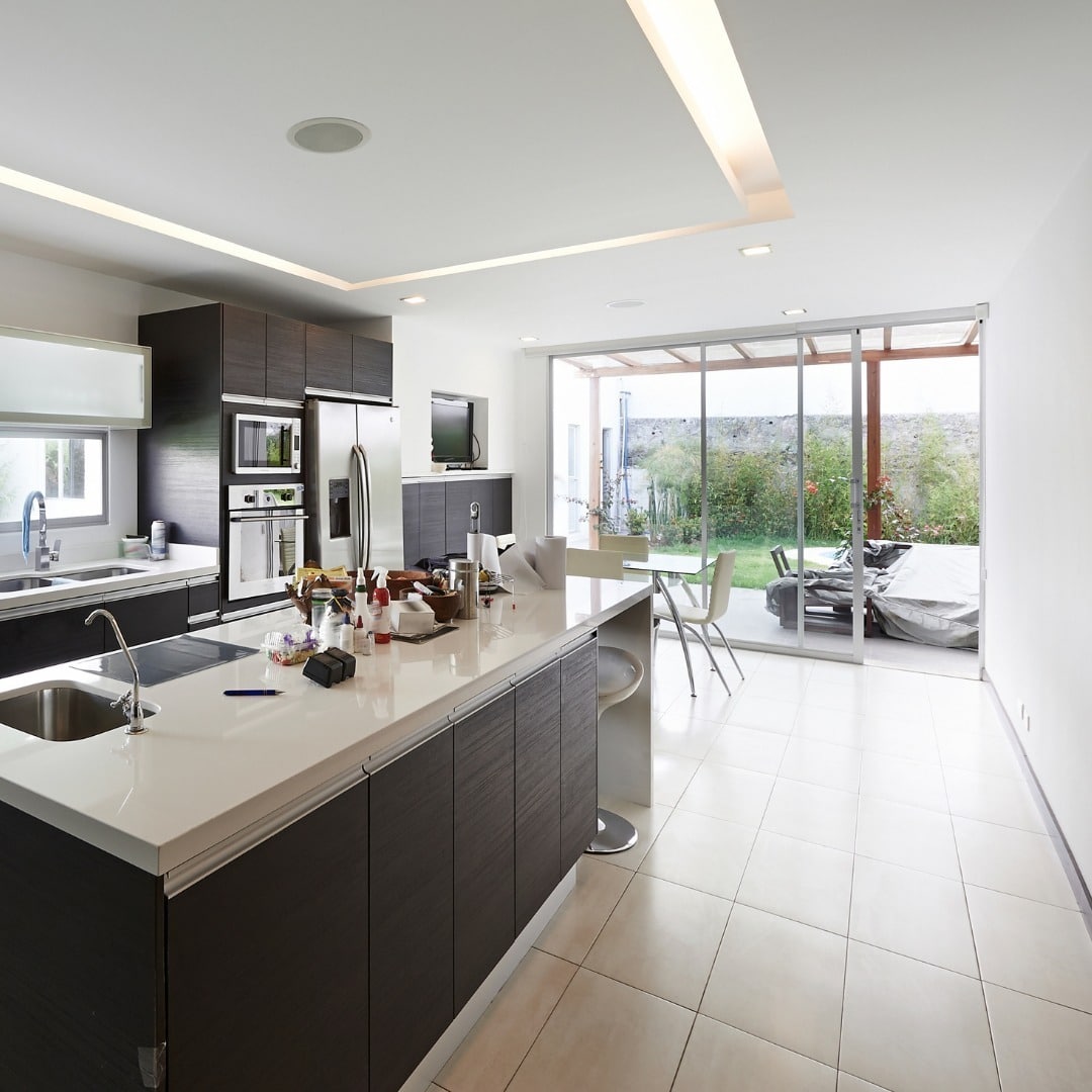 13. Sleek Black and White Kitchen with Indoor-Outdoor Connection - big kitchen ideas