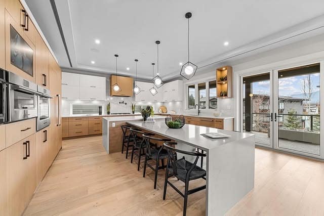 14. Light Wood and White Kitchen with Linear Island Design - big kitchen ideas