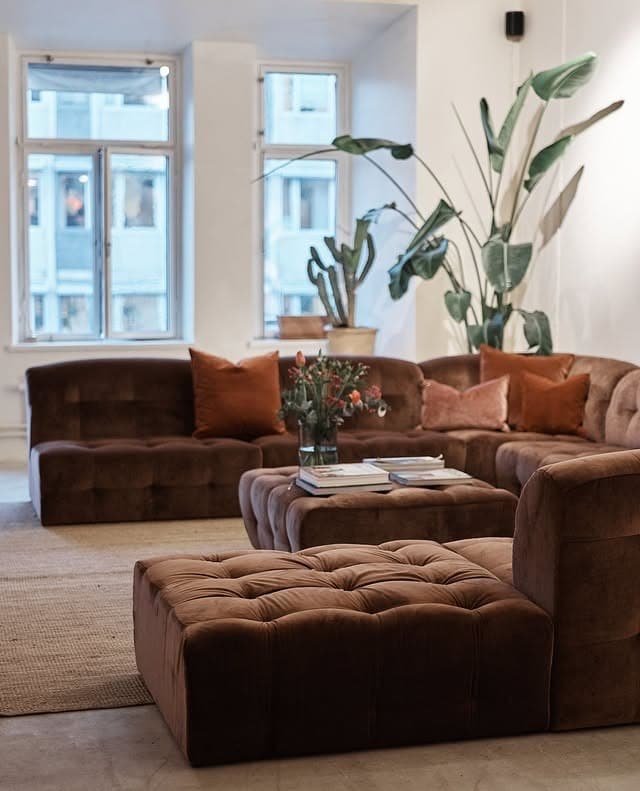 1. Sculptural Dark Brown Modular Sofa in a Soft Minimal Living Room - dark brown sofa living room ideas