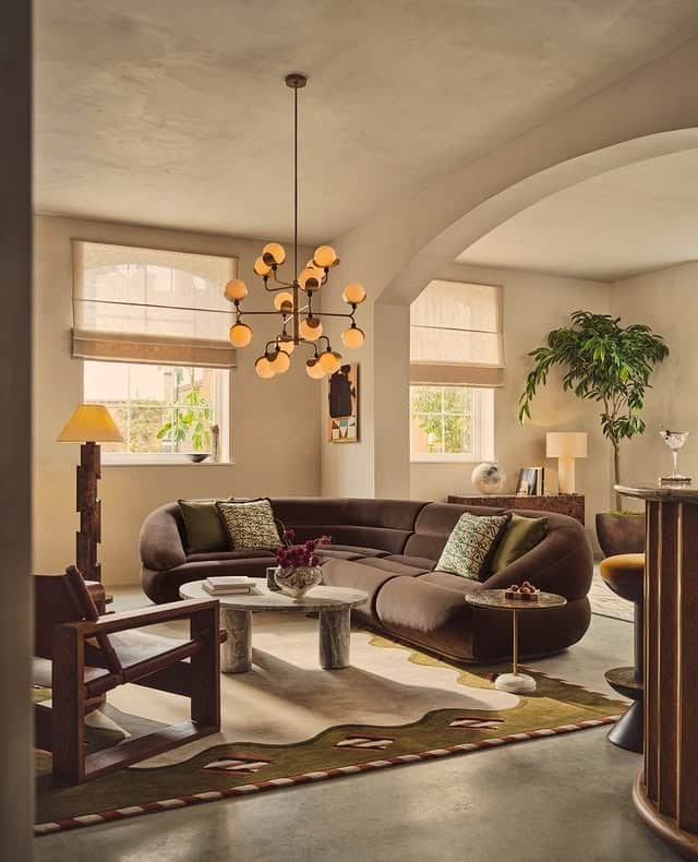 7. Curved Dark Brown Sofa in Elegant Transitional Living Room - dark brown sofa living room ideas