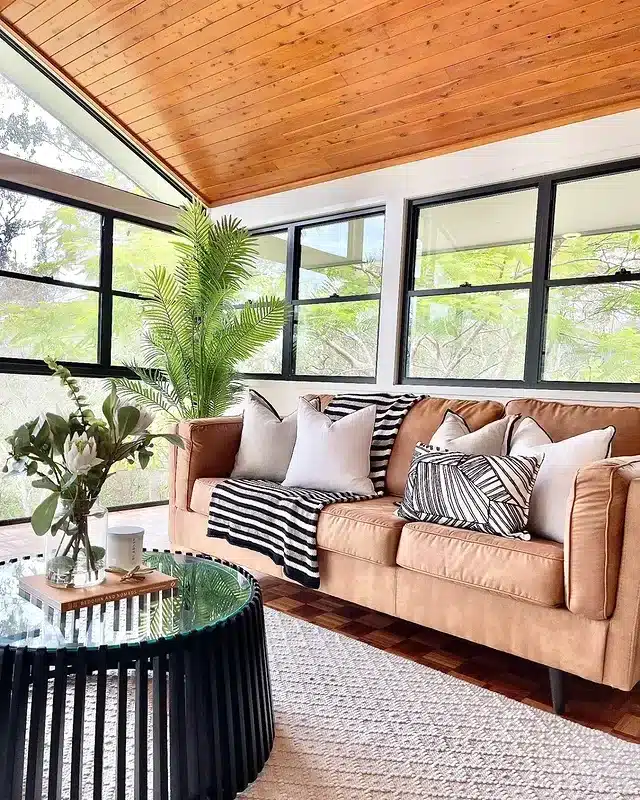 10. Tan Brown Sofa with Natural Light and Indoor-Outdoor Feel - dark brown sofa living room ideas