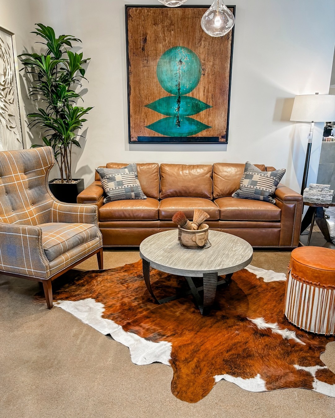 12. Cognac Brown Sofa with Southwestern-Inspired Textures and Artwork - dark brown sofa living room ideas