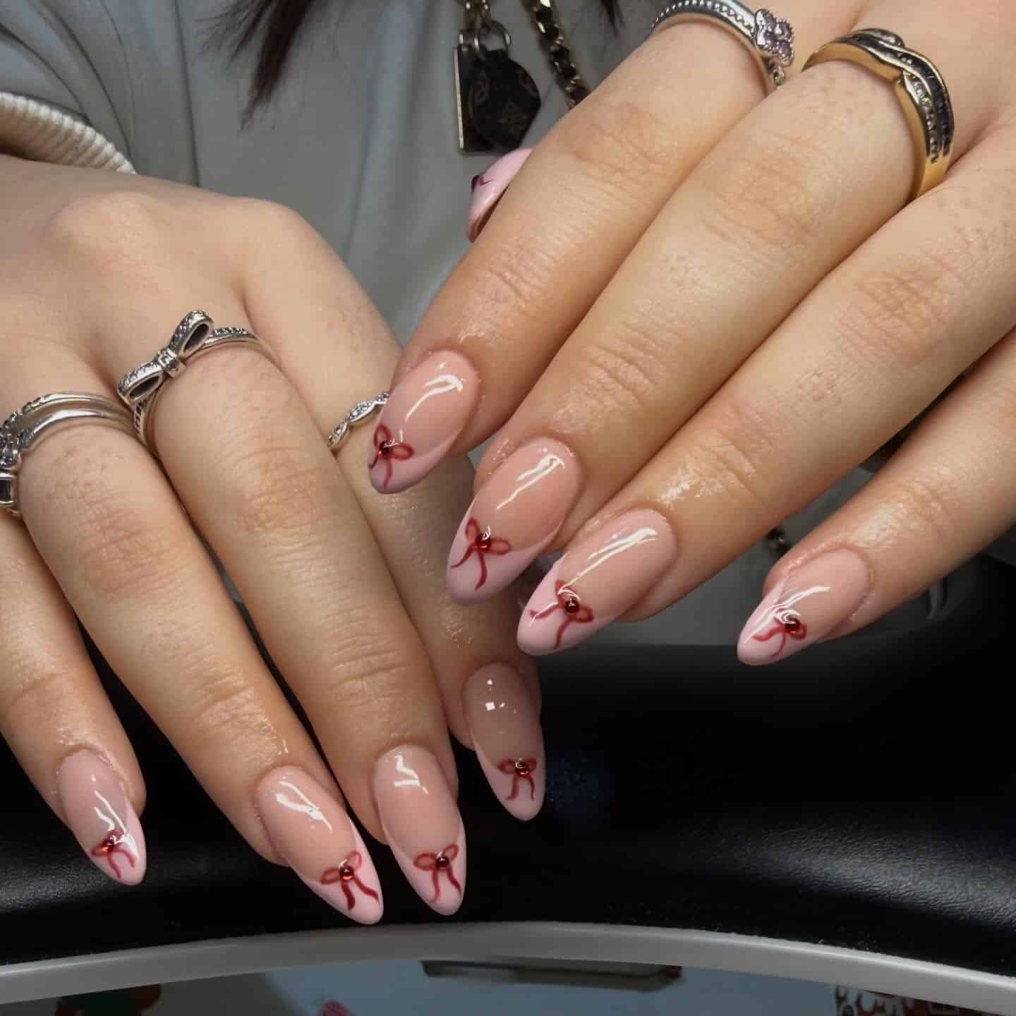 10. Classic Nude Almond Nails with Micro Red Bow Details - nail ideas with bows