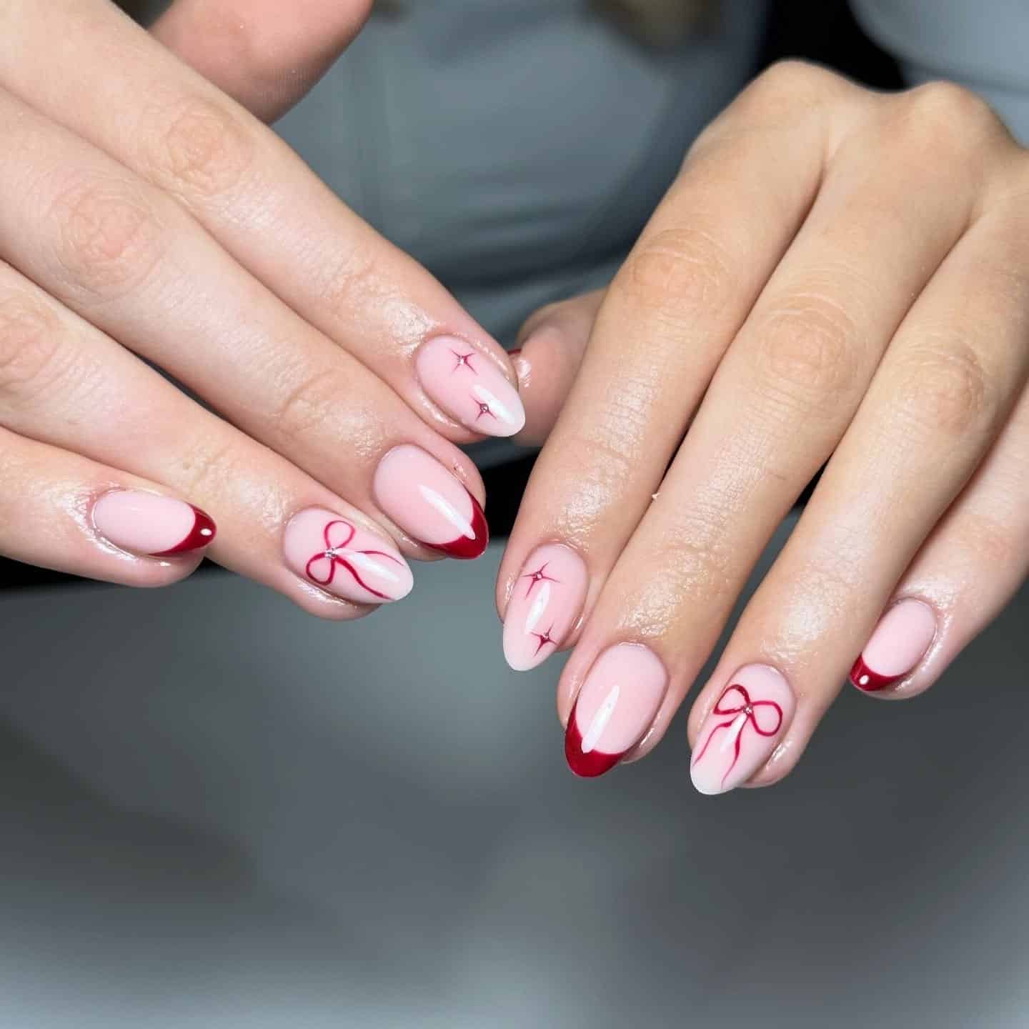 11. Blush Pink Almond Nails with Deep Red French Tips and Bow Art - nail ideas with bows