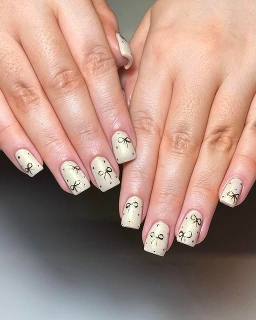 13. Soft Nude Square Nails with Black Bow Micro Art - nail ideas with bows