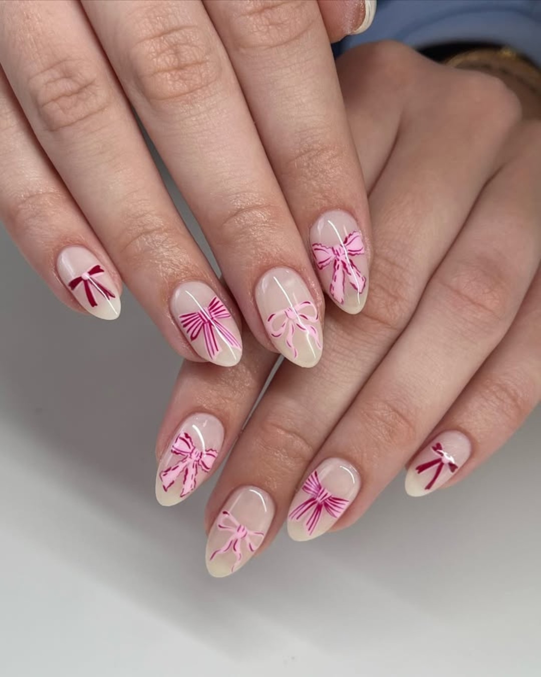 21. Soft Nude Almond Nails with Pink Bow Line Art - nail ideas with bows