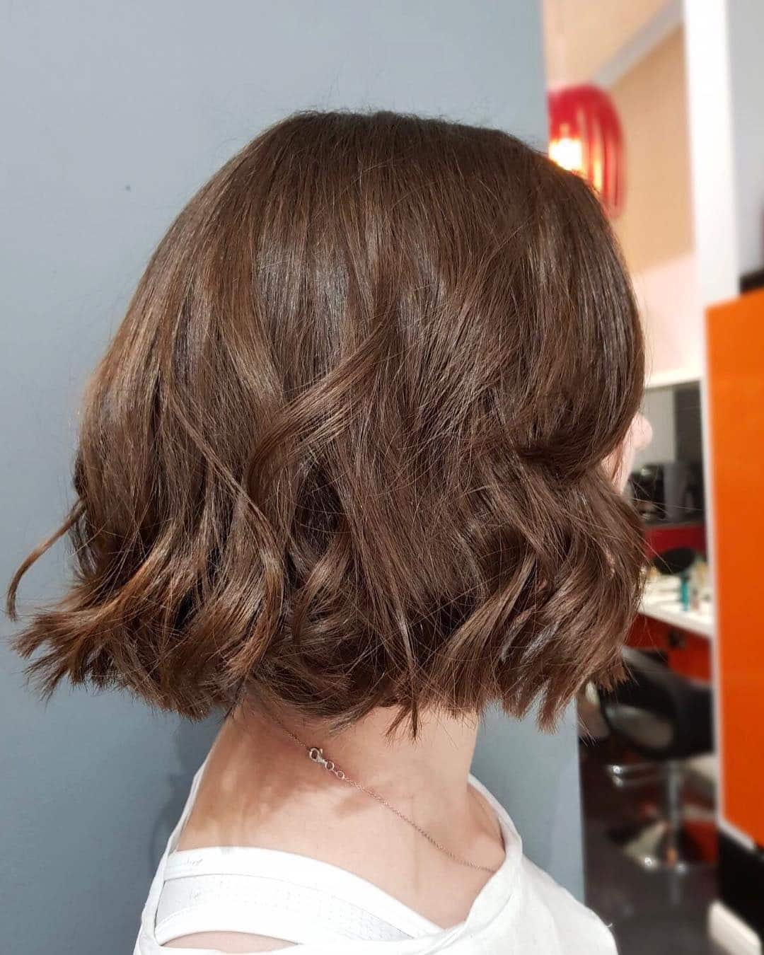 8. Layered Wavy Bob with Subtle Caramel Accents - Tousled Bob Haircut