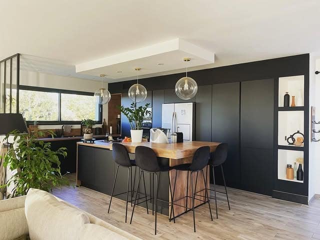 12. Open Concept Black Kitchen with Wood Dining Island - black and wood kitchen ideas