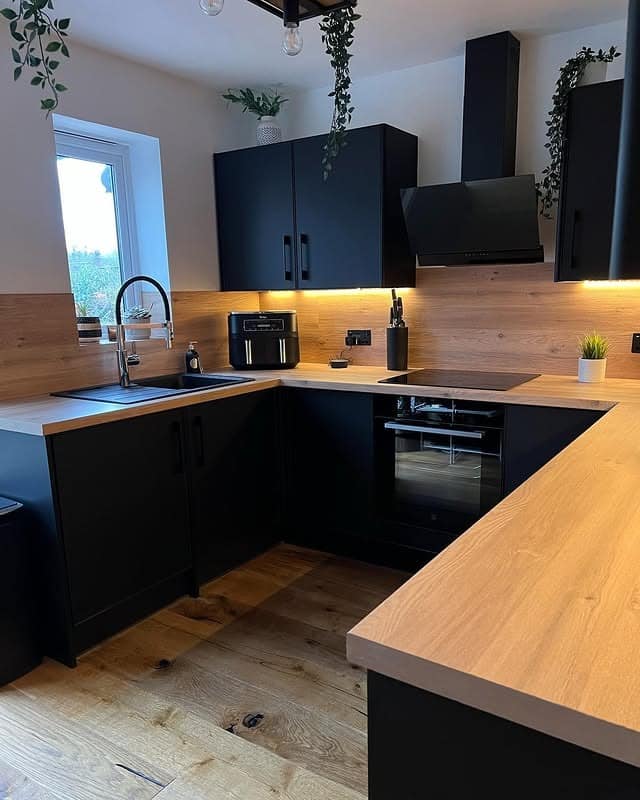 17. Compact Black and Wood Kitchen with Warm Underlighting - black and wood kitchen ideas