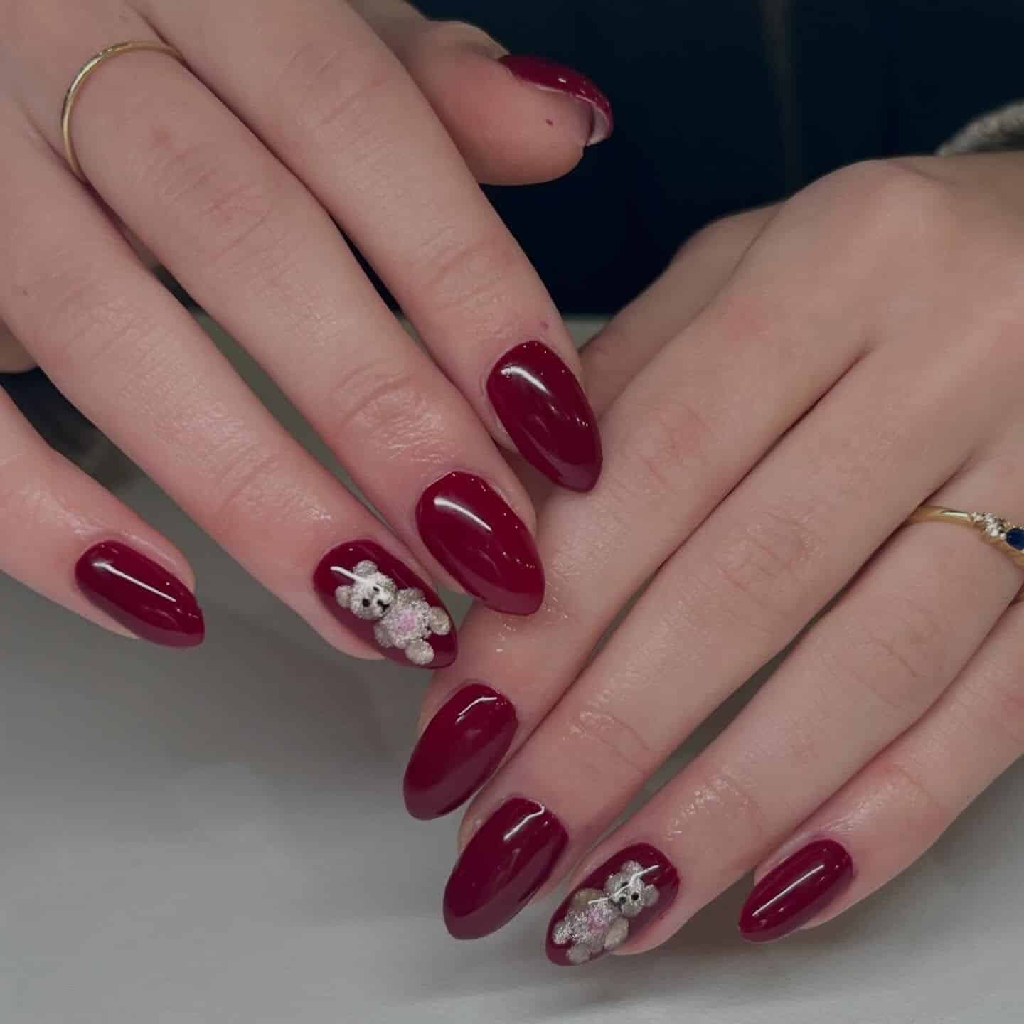 9. Deep Burgundy Almond Nails with 3D Teddy Accent - red nail ideas