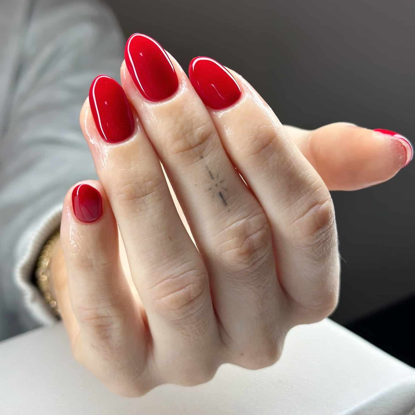 16. Glossy Red Oval Nails with Natural Finish - red nail ideas