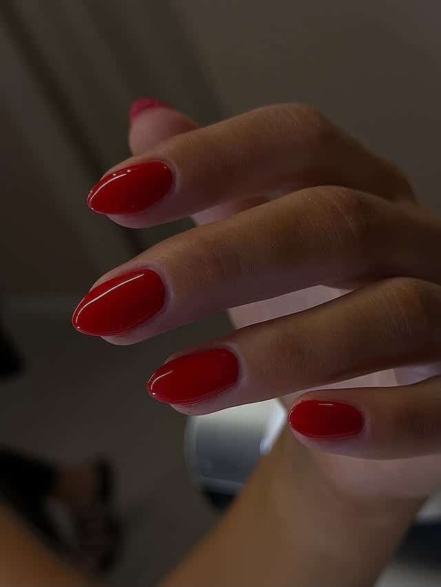20. Minimal Glossy Red Short Almond Nails - red nail ideas