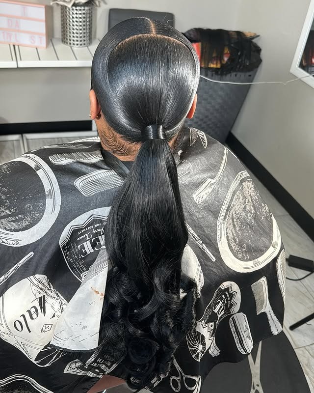 14. Middle Part Sleek Low Ponytail Jet Black - Middle Part Hairstyles