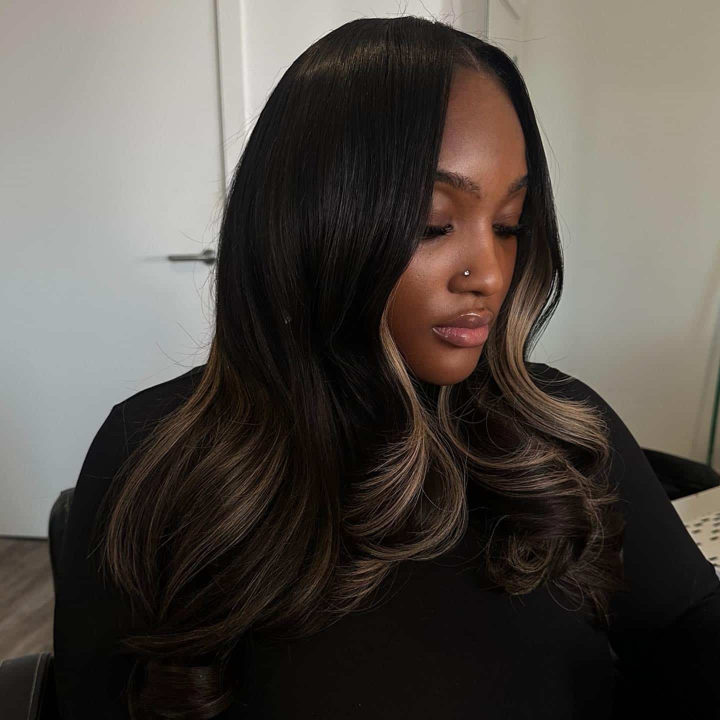 18. Middle Part Face-Framing Blonde Highlights on Black Waves - Middle Part Hairstyles