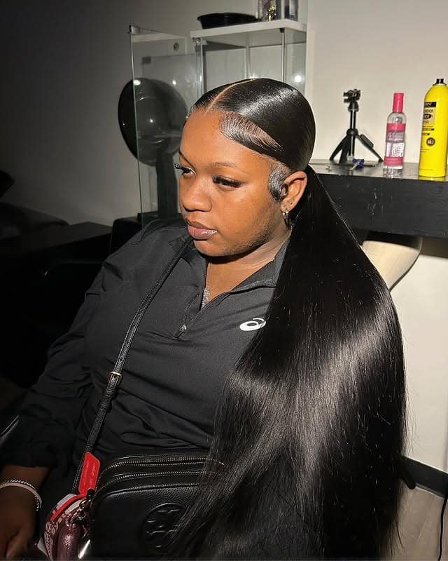 20. Sleek Middle Part Low Ponytail Glossy Black Finish - Middle Part Hairstyles