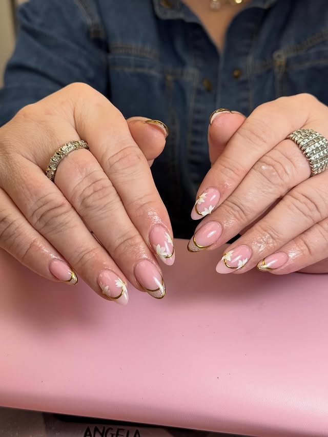 4. Almond French with Gold Outline and Floral Detail - school nail ideas