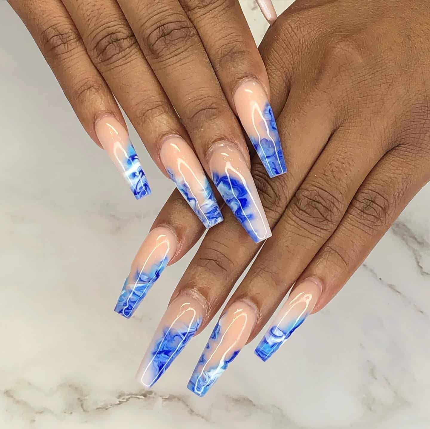9. Long Coffin Nude and Blue Marble Nails - school nail ideas