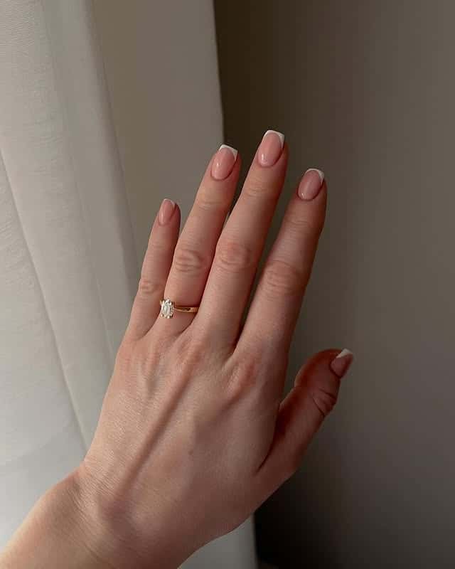 9. Minimalist French Tip Natural Oval Nails - old money nail ideas