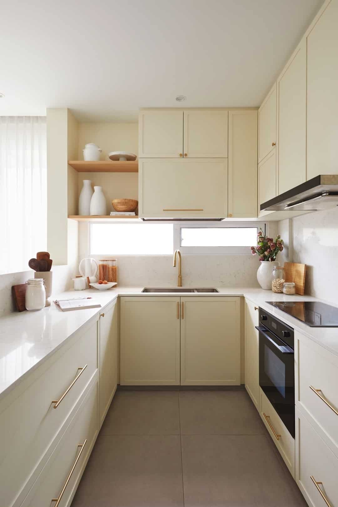 10. Compact Cream Kitchen with Gold Hardware - cream kitchen cabinet ideas