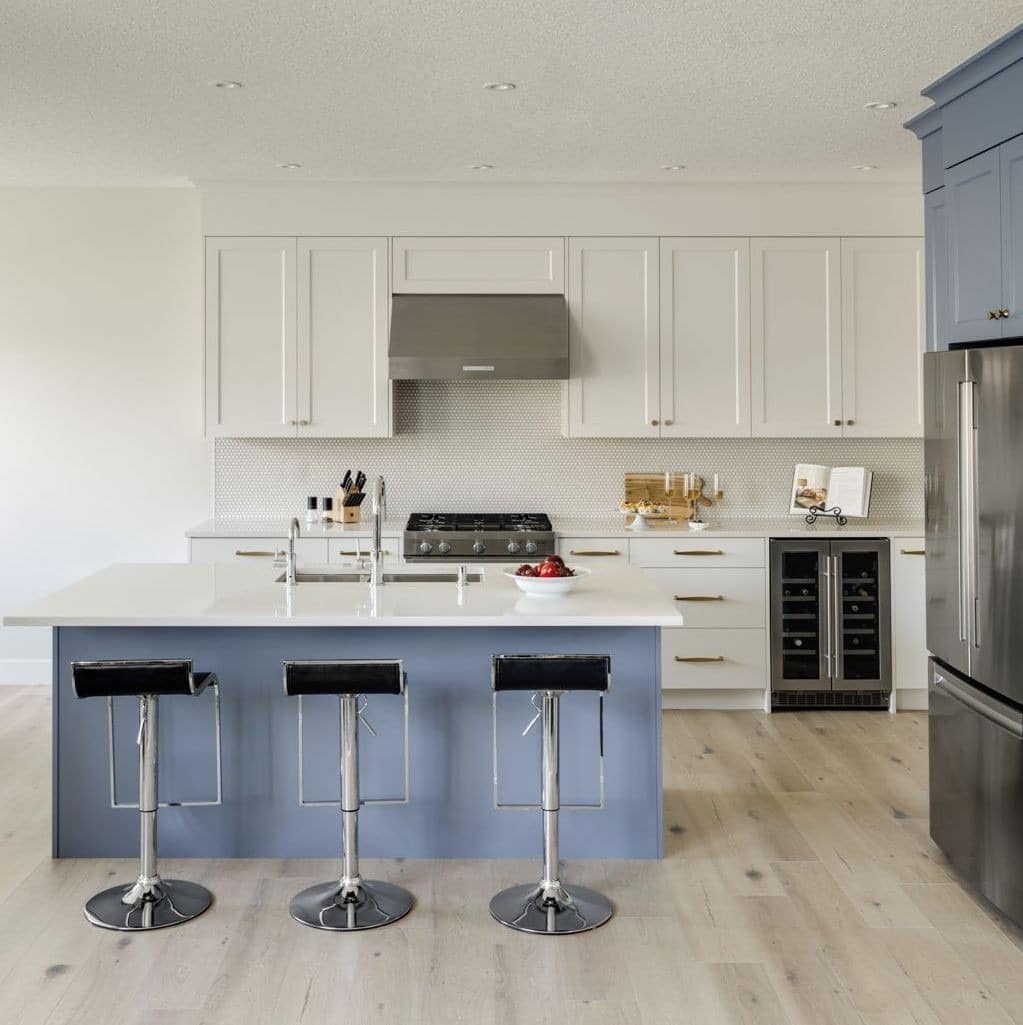 13. Cream Cabinets with Soft Blue Island Contrast - cream kitchen cabinet ideas