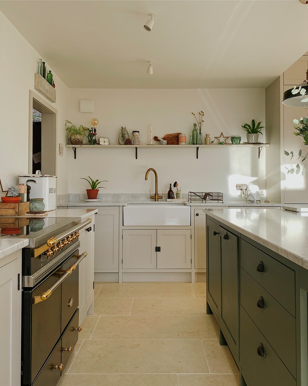 15. Cream Kitchen with Farmhouse Touches and Dark Island - cream kitchen cabinet ideas
