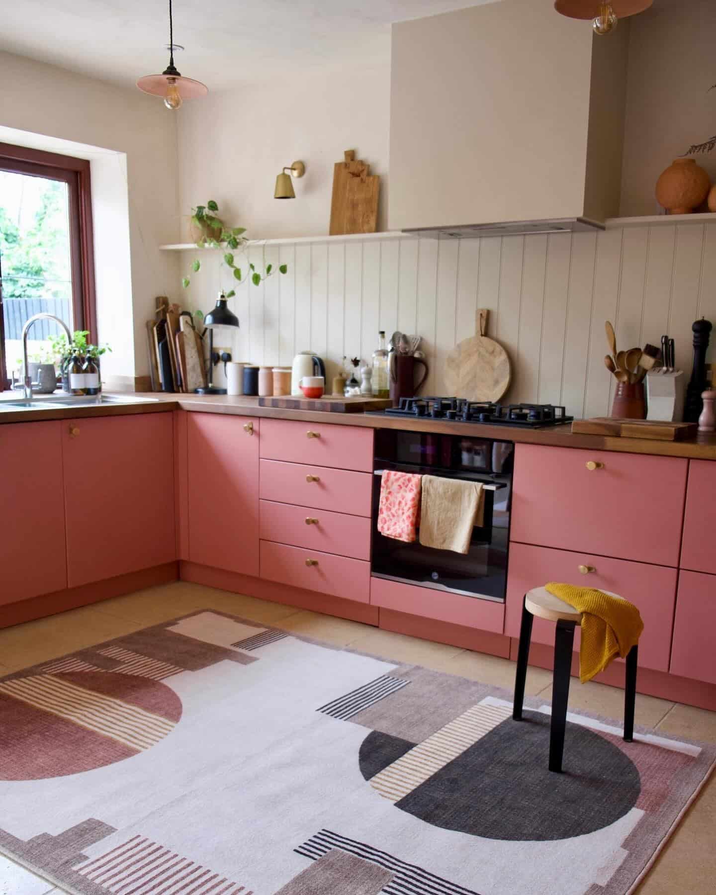13. Warm Coral Pink Kitchen with Natural Wood Accents - pink kitchen ideas