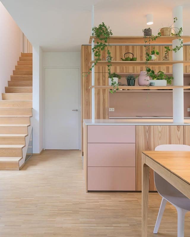 16. Soft Pink Scandinavian Kitchen with Open Shelving Divider - pink kitchen ideas