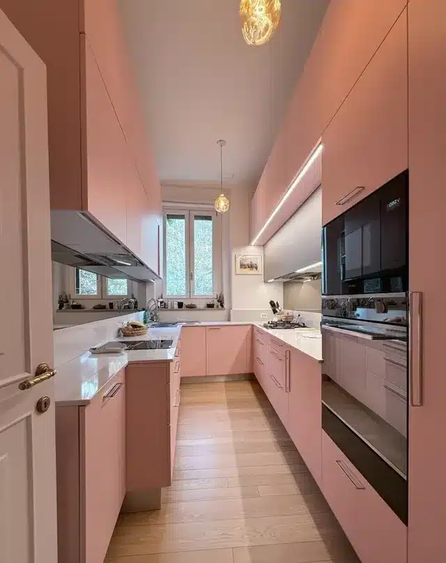 19. Sleek Light Pink Galley Kitchen with Integrated Lighting - pink kitchen ideas