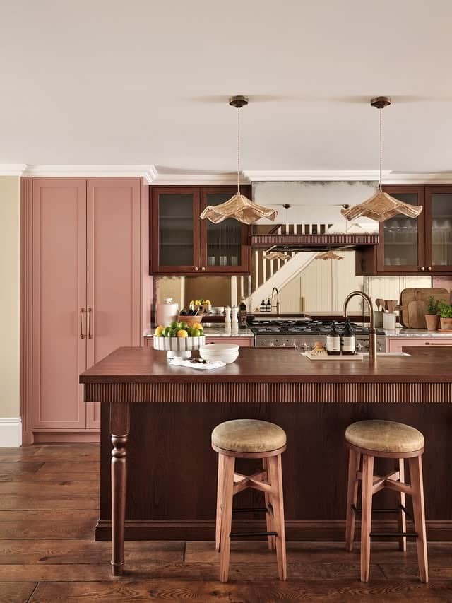 20. Classic Pink Kitchen with Rich Wood Island and Traditional Details - pink kitchen ideas