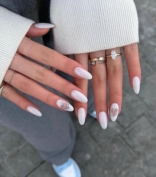 12. Glossy White Almond Nails with Crystal Heart Detail - white nail ideas