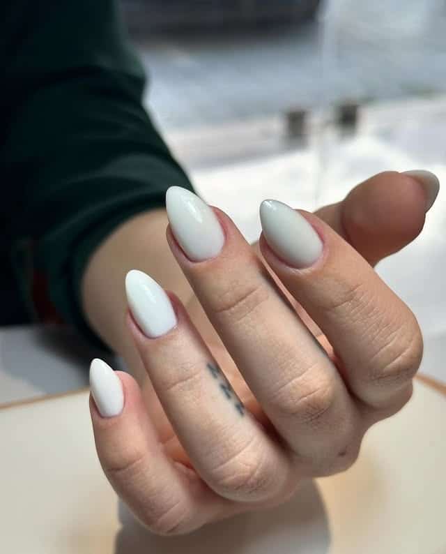 14. Classic Glossy White Short Almond Nails - white nail ideas