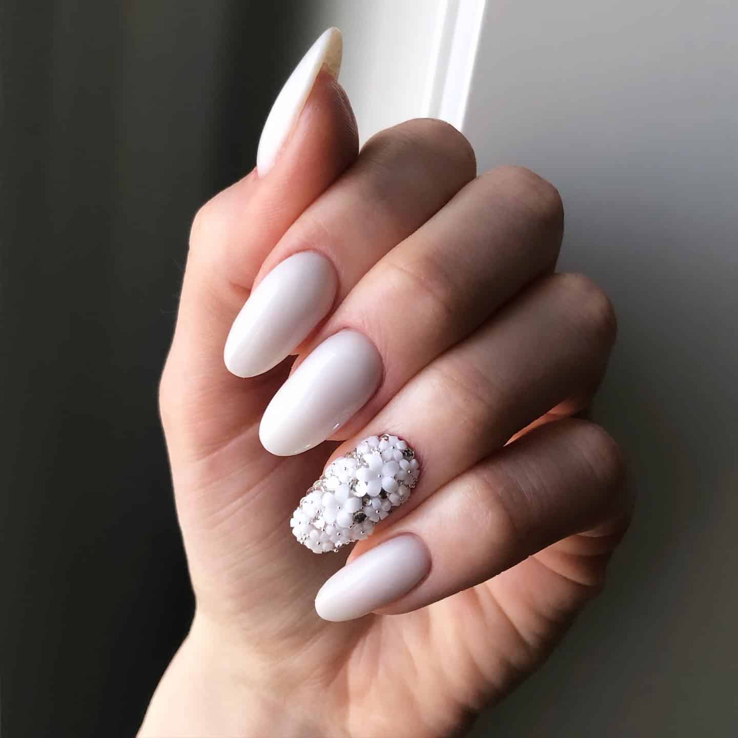 20. Matte White Almond Nails with 3D Floral Accent - white nail ideas