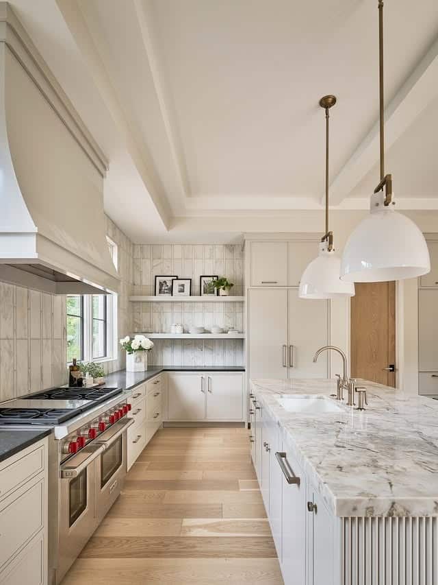 7. Contemporary Dark Kitchen with Sculptural Island - luxury kitchen ideas