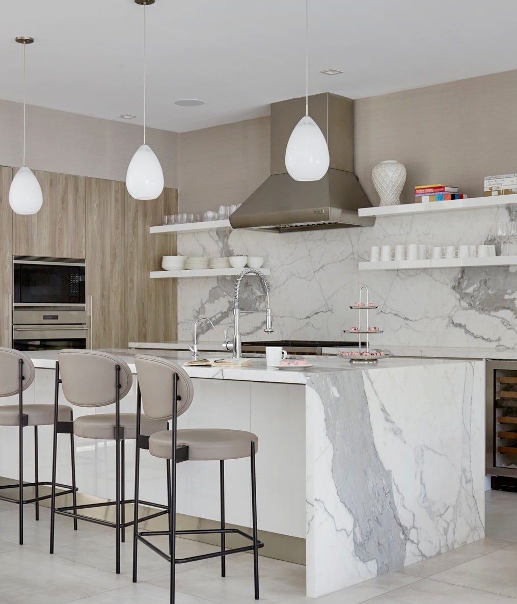 10. High-End Neutral Kitchen with Waterfall Marble Island - luxury kitchen ideas
