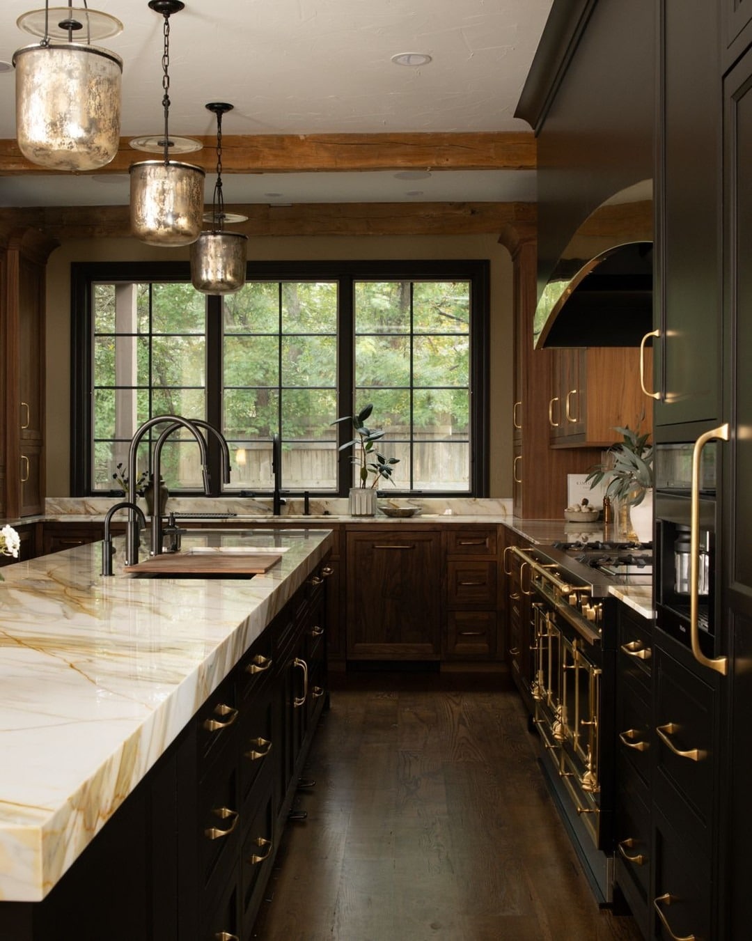 18. Classic Dark Kitchen with Gold Hardware and Marble Surfaces - luxury kitchen ideas