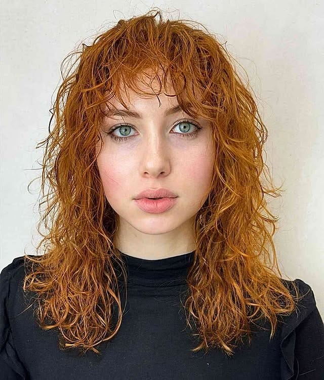 8. Layered Auburn Curly Wolf with Fringe - Curly Wolf Haircut
