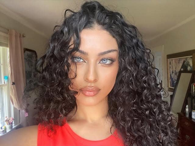 11. Long Jet Black Curly Wolf Cut with Face-Framing Layers - Curly Wolf Haircut