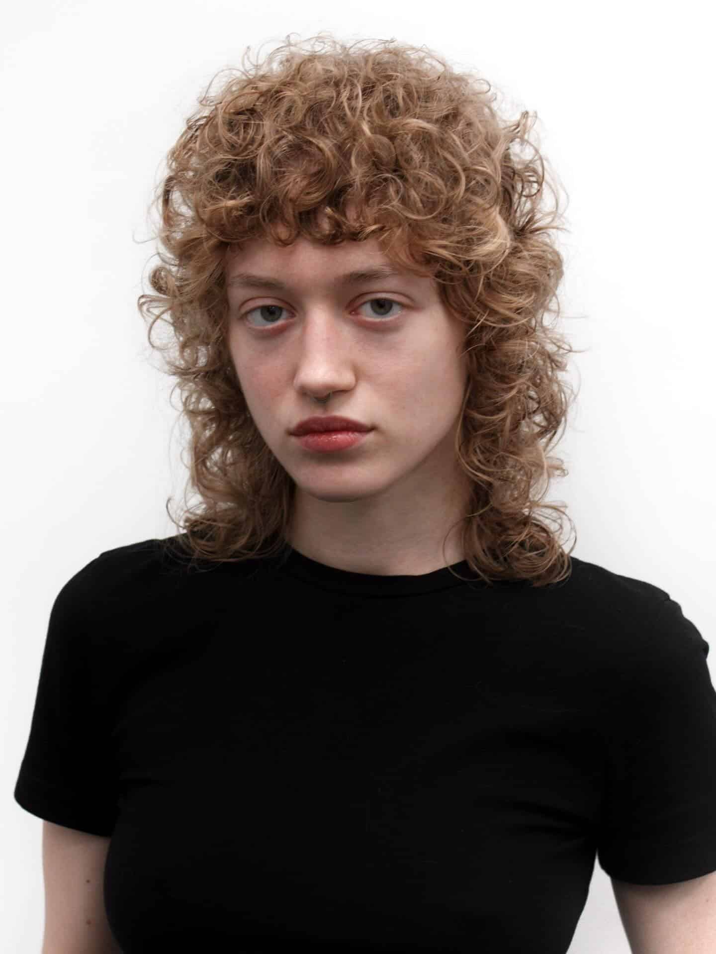 12. Sandy Blonde Curly Wolf Shag with Soft Fringe - Curly Wolf Haircut