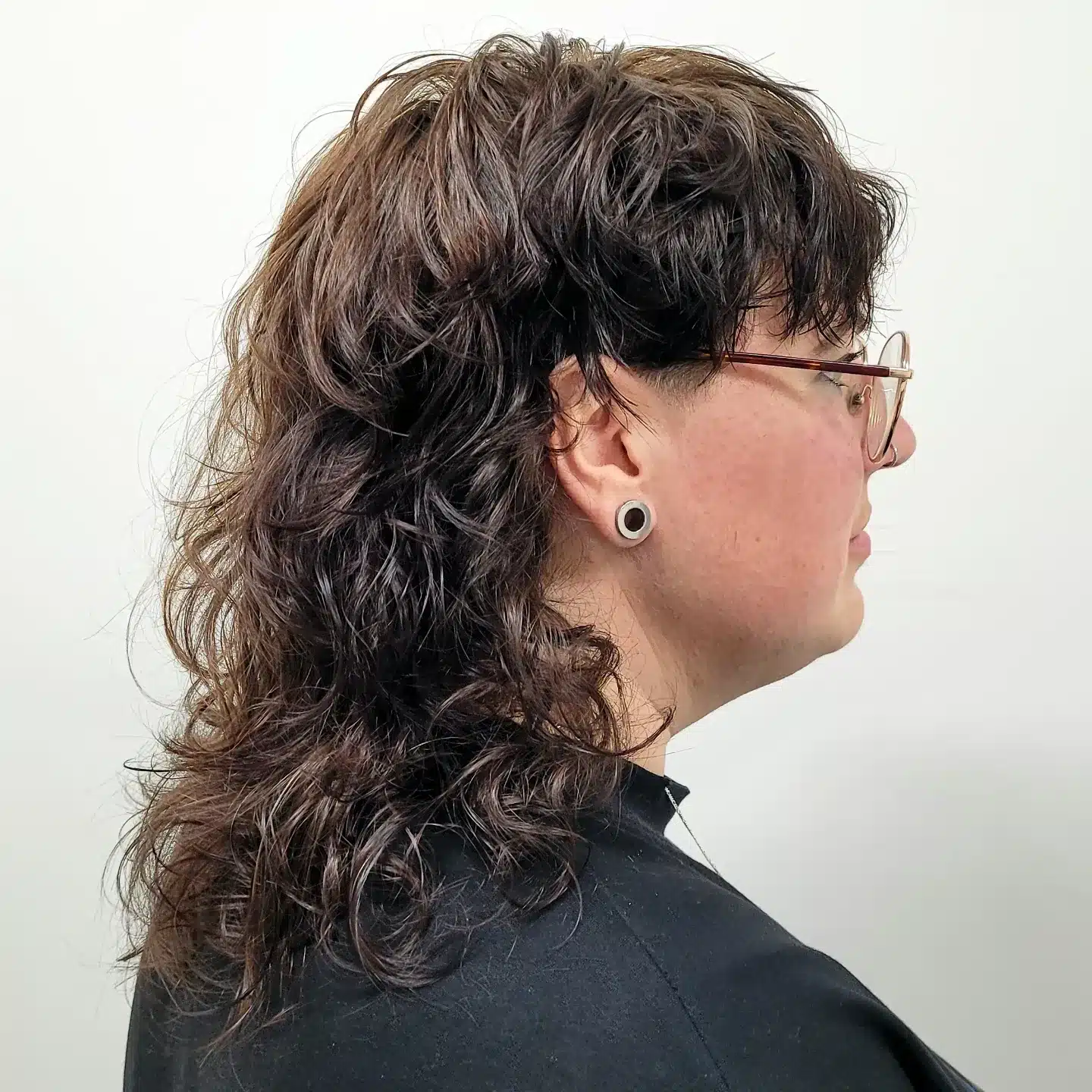 14. Dark Brunette Curly Wolf Mullet with Undercut Detail - Curly Wolf Haircut
