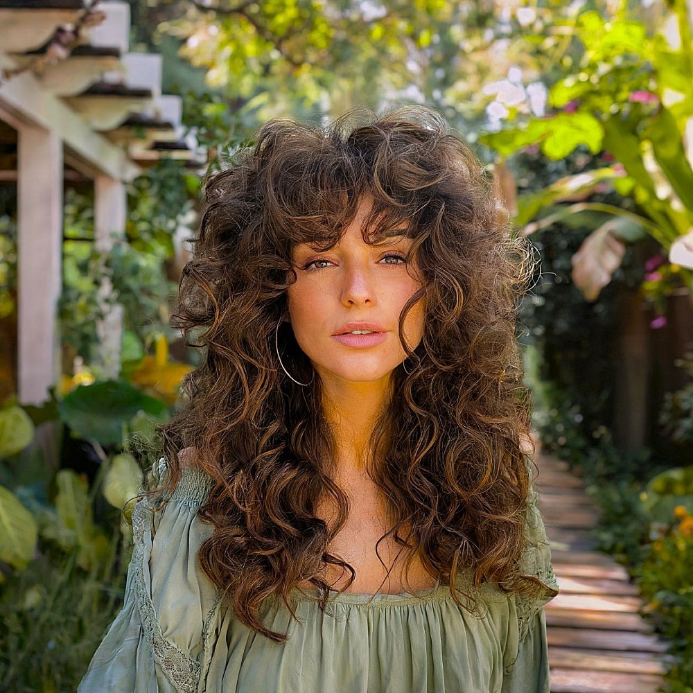 21. Voluminous Chestnut Curly Wolf Cut with Full Fringe - Curly Wolf Haircut