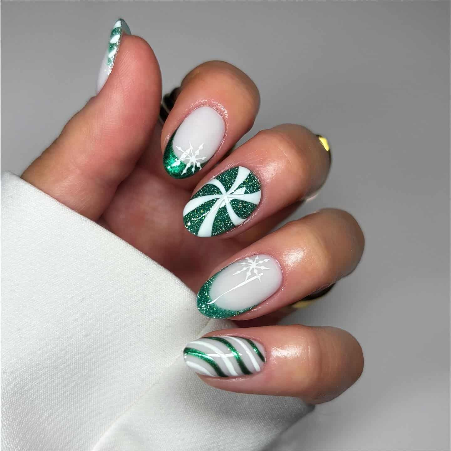 17. Green and White Swirl French with Snowflake Detail - green christmas nail ideas