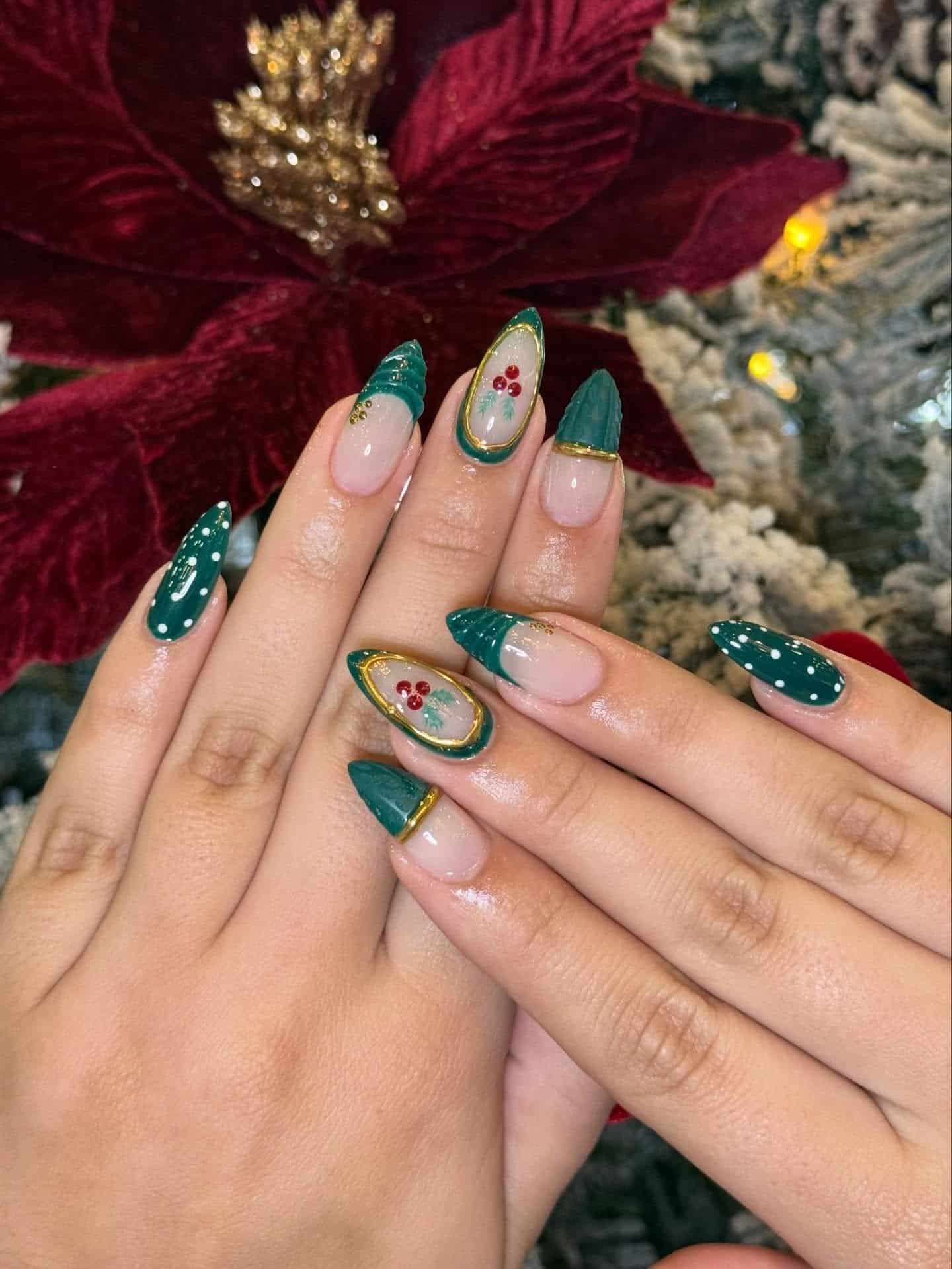 20. Emerald French Almond Nails with Gold Trim and Holly Art - green christmas nail ideas