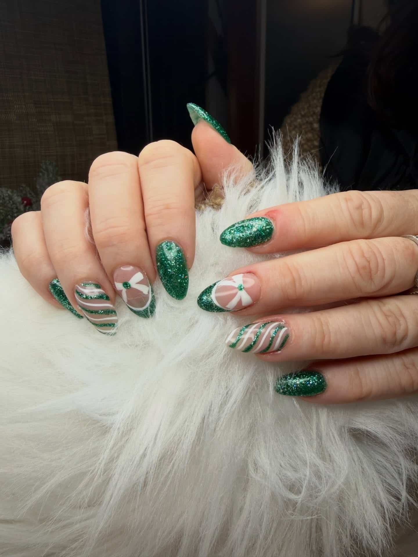 22. Emerald Glitter Almond Nails with Swirl and Floral Accents - green christmas nail ideas